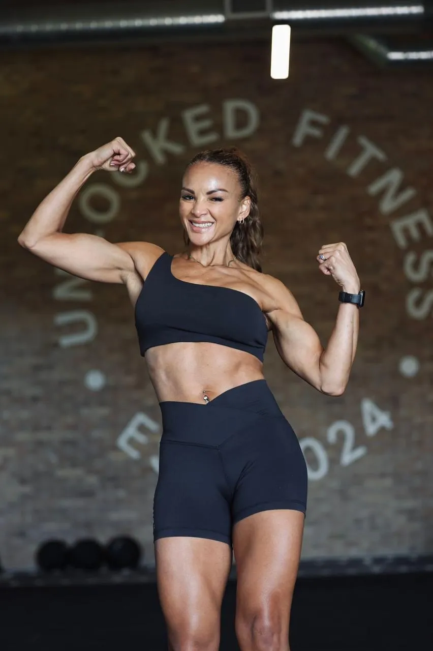 Clauds flexing and winking at Unlocked Fitness